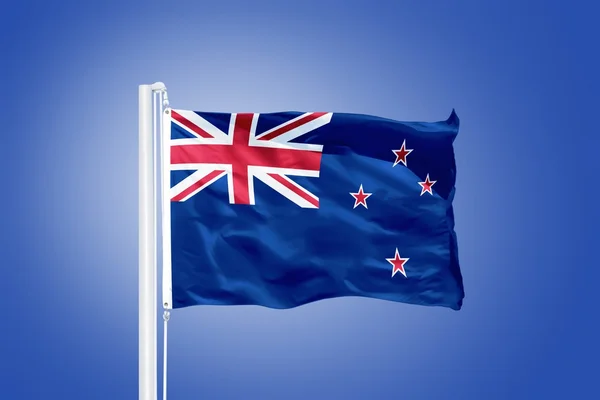 Flag of New Zealand flying against a blue sky — Stock Photo, Image