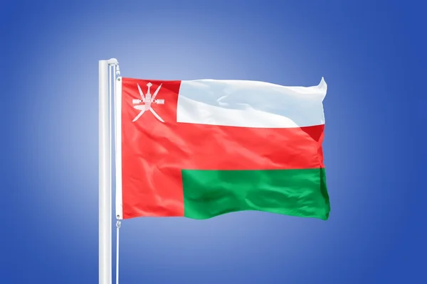 Repülő szemben a kék eget Omán zászlaja — Stock Fotó