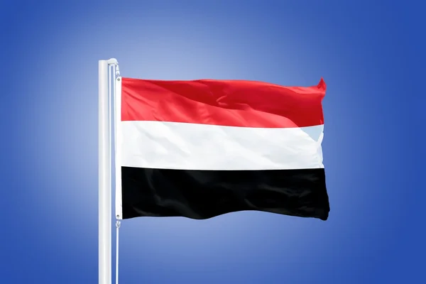 Flag of Yemen flying against a blue sky — Stock Photo, Image