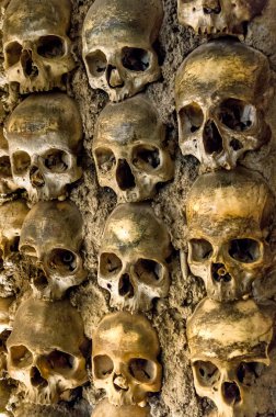 Wall full of skulls and bones in the bone chapel in Evora, Portugal clipart