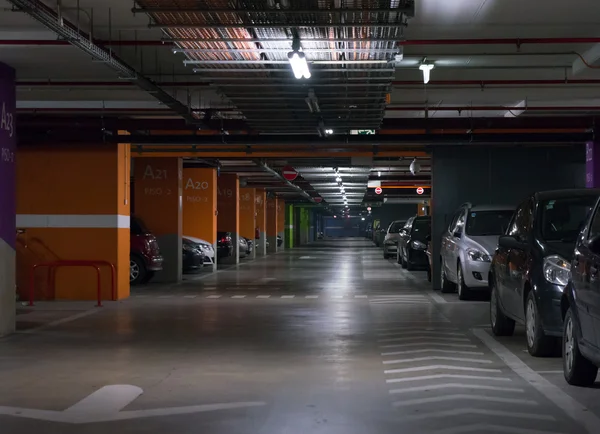 Parking garage, underground interior with a few parked cars — Stock Photo, Image