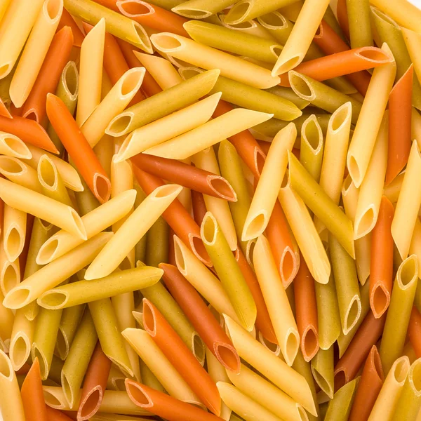 Pasta Penne colorata textur bakgrund — Stockfoto