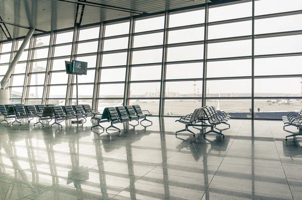 Airport waiting area seats and window — Stock Photo, Image