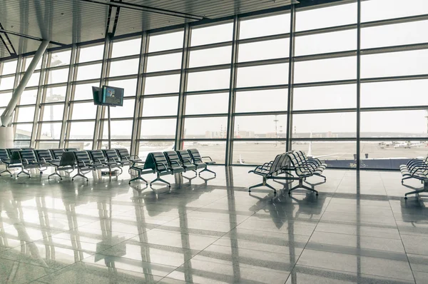 Area d'attesa dell'aeroporto, posti a sedere e fuori dalla finestra — Foto Stock