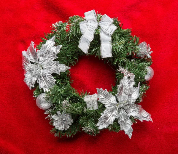 Christmas wreath with baubles on a red — Stock Photo, Image