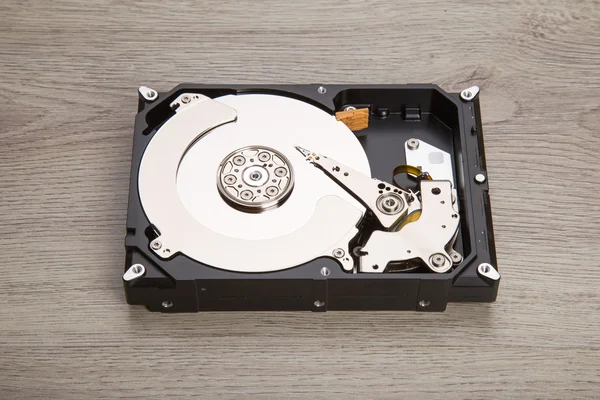 Open harddisk on wood desk — Stock Photo, Image