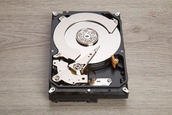 Open harddisk on wood desk — Stock Photo, Image