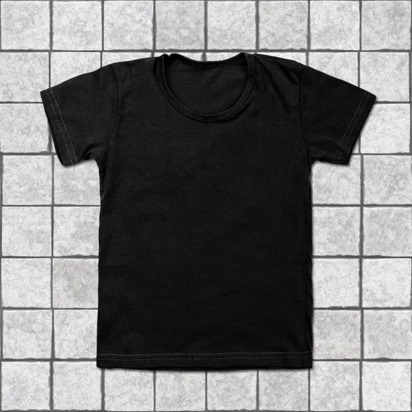 Black blank t-shirt on tile background — Stock Photo, Image