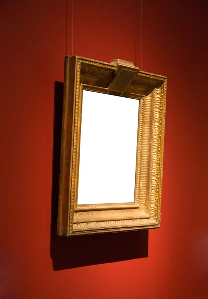 Ornate gold blank frame at wall — Stock Photo, Image