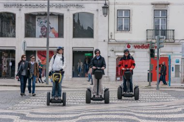 Tourist group having guided Segway city tour in Lisbon clipart