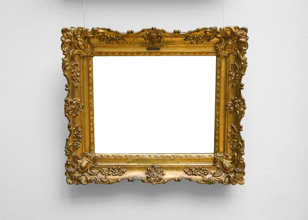 Gold empty frame on white wall — Stock Photo, Image