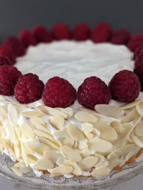 Beyaz arka planda kremalı ahududu turtası.