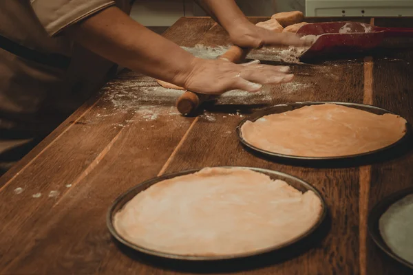 Hands with rolling kneading dough — Stock Photo, Image