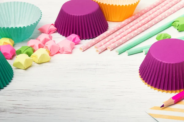 Colorful paper straws, stars and cupcake cups Royalty Free Stock Images