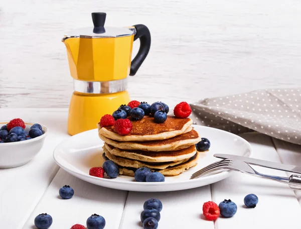 Pancakes with berries on the white table — Stock Photo, Image