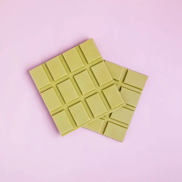 Square bars of milk chocolate of green color — Stock Photo, Image