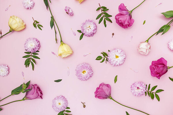 Creative flat lay composition with flowers, leaves and petals.