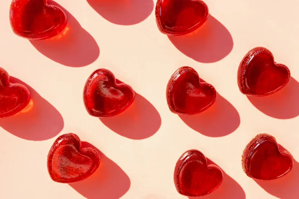 Small heart shaped jelly candies with hard shadows. — Stock Photo, Image