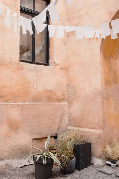 Vintage inner yard decorated with hanging pieces of white cloth — Stock Photo, Image