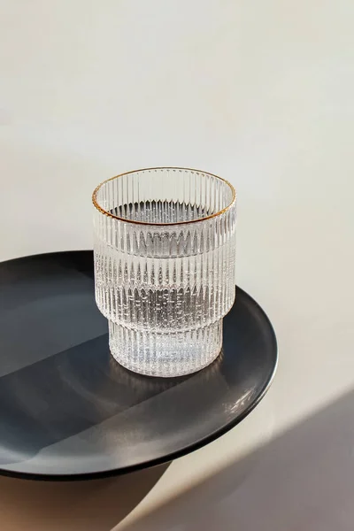Water glass with strong shadows