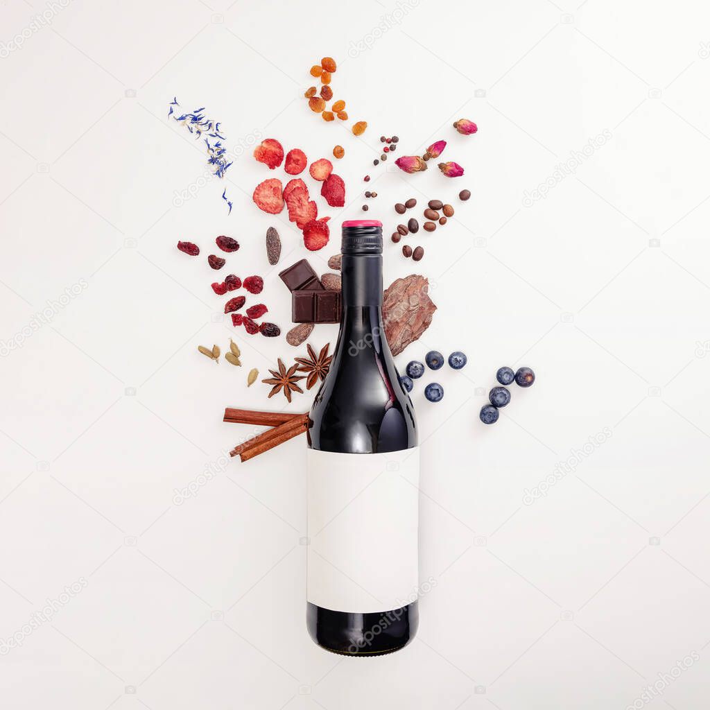 Composition with wine bottle and possible flavor components of red wine