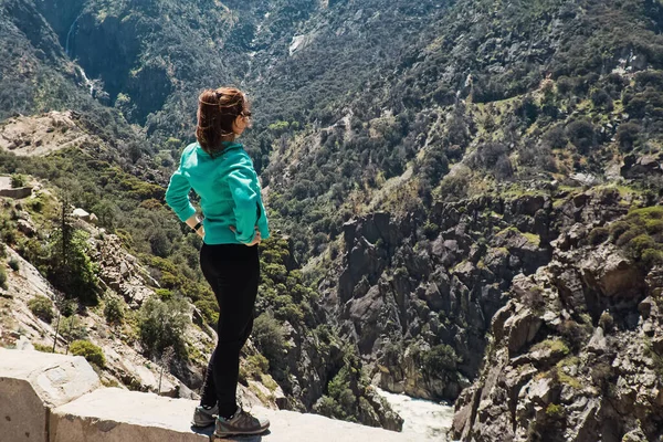 年轻女子徒步旅行者站在那里观望. — 图库照片