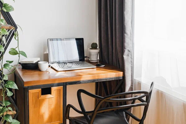 Moderno lugar de trabajo en casa con ordenador portátil en mesa de madera —  Fotos de Stock