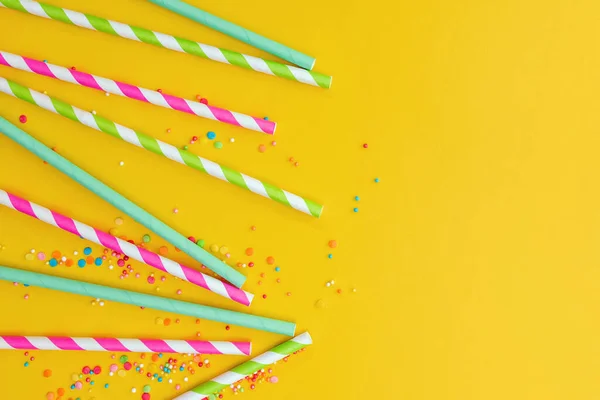 Multicolored party drinking straws and sugar sprinkles — Stock Photo, Image