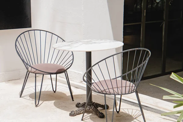 Stylish modern chairs and stone table on the spacious terrace