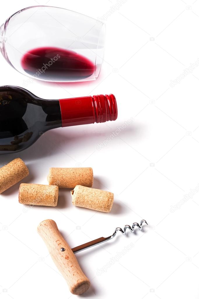 Bottle, glass with red wine, corks and corkscrew