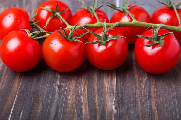 Red cherry tomatoes on the wooden table — Stock Photo, Image