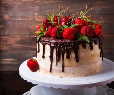Delicious cake with strawberry and cherry