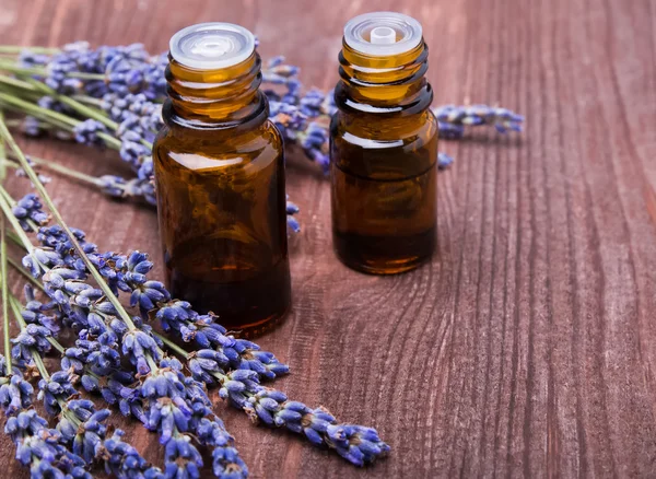 Due bottiglie di oli aromatici e fiori di lavanda — Foto Stock