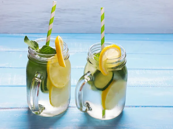 Lemon and cucucmber detox water in glass jars — Stock Photo, Image