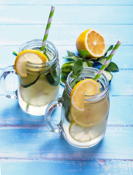 Lemon and cucucmber detox water in glass jars — Stock Photo, Image