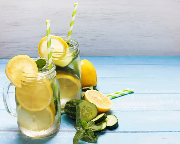 Lemon and cucucmber detox water in glass jars — Stock Photo, Image