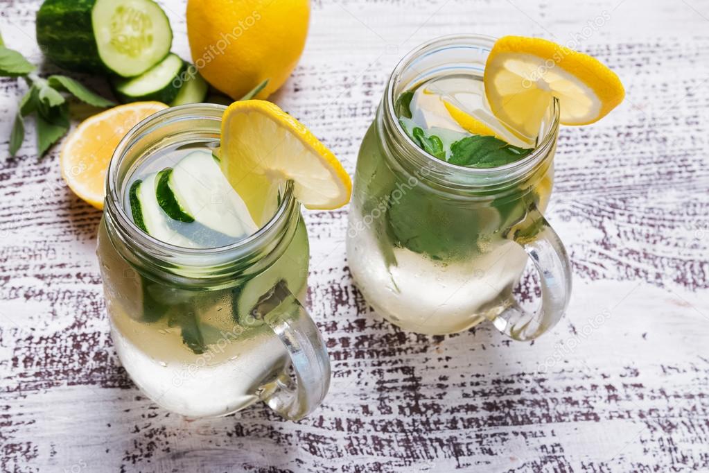 Lemon and cucumber detox water in glass jars