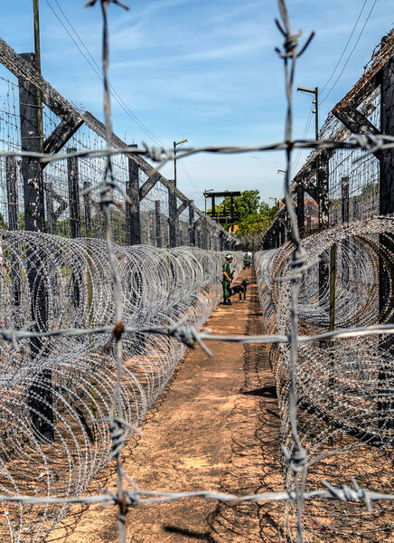Barbwire secure border engineering protection wall. Fence with metal barb electricity wire of the prison. Coconut Prison Phu Quoc Island Vietnam War museum. Phu Quoc, Vietnam - December 17, 2014