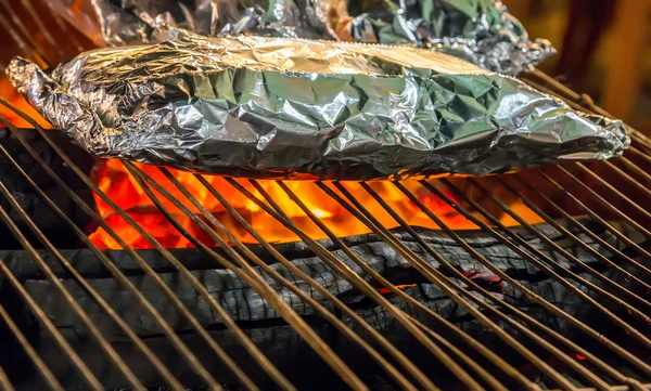 Food in on aluminum foil Barbecue Grill — Stock Photo, Image