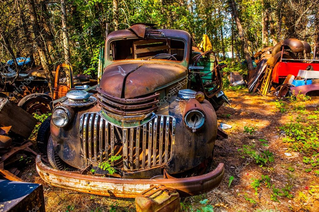 Old rusted car in junk yard - Stock Editorial Photo ...