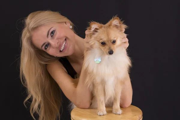 Portrait of a cute blondie with pomeranian dog — Stock Photo, Image