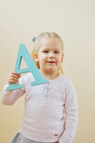 Toddler girl with letter — Stock Photo, Image