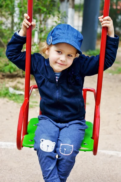 Little girl sitting on swing — Stock Photo, Image