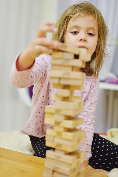 Little girl with wooden blocks Stock Image