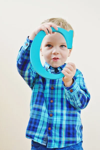 Boy with a wooden letter — Stock Photo, Image