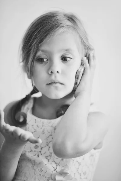 Little girl talking by phone — Stock Photo, Image