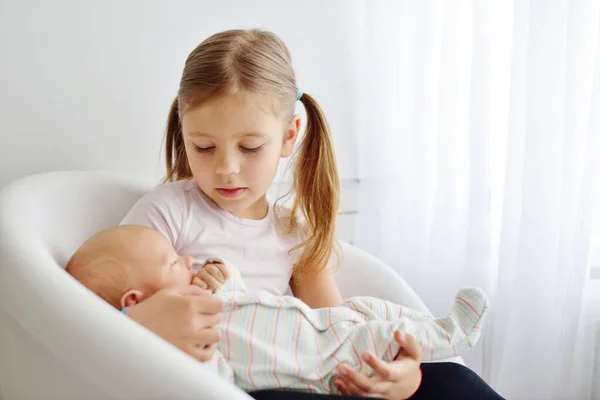 Sister Holding Her Newborn Brother Home — Stock Photo, Image