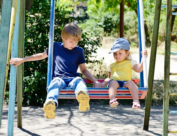 Brother and sister on the swing — Stock Photo, Image