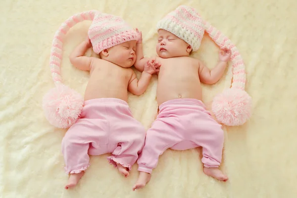 Twins wearing funny hats — Stock Photo, Image