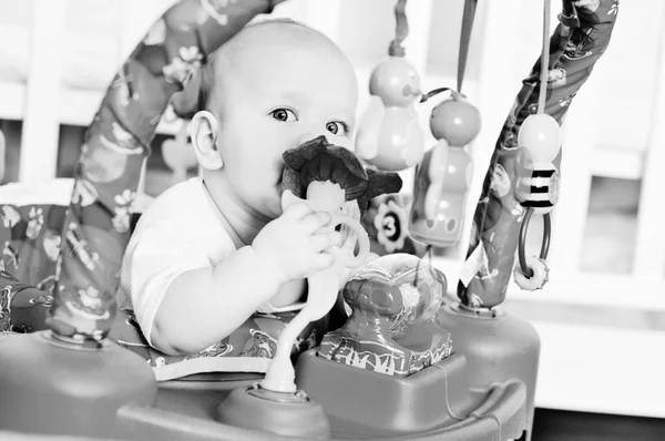 Baby in baby jumper — Stockfoto